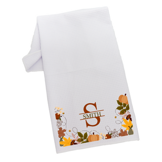 White towel with fall leaf and pumpkin design.