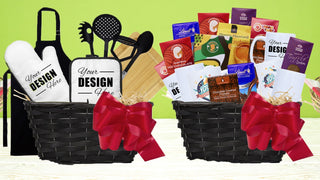 2 beautiful gift baskets sit on  a table.  one basket is filled with custom kitchen supplies, one is filled with chocolate and custom mugs.