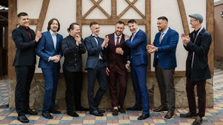 A group of young men in nice suits are gathered to celebrate their friends wedding.