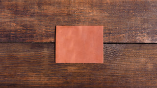 A leather patch sits on wooden floor boards.