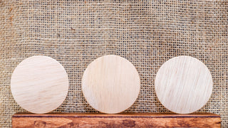 Image shows white round coasters that demonstrate their ability to be personalized.