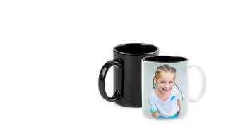 A white and a black photo mug sit side by side.  The front one is white and has a photo of a young girl smiling on it.