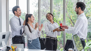 Group of young employees celebrate with a custom award