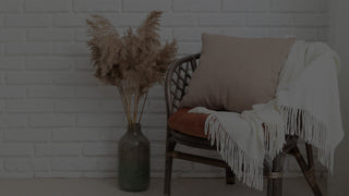 White Pillow on a Blue Couch.  The White Pillow has a family photo printed on it.