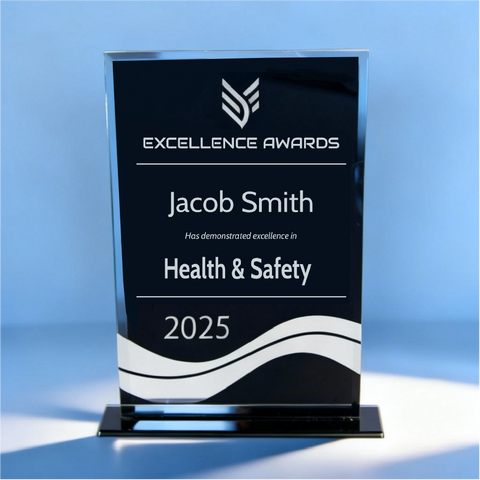 Black and clear glass award with text.